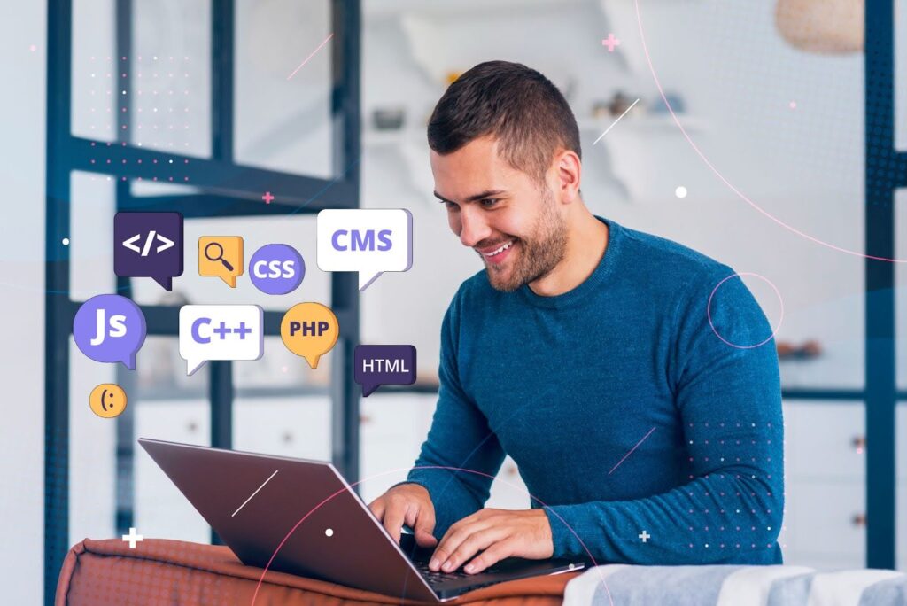 A man sits on a couch with a laptop displaying icons related to web app development and how to build a web app.